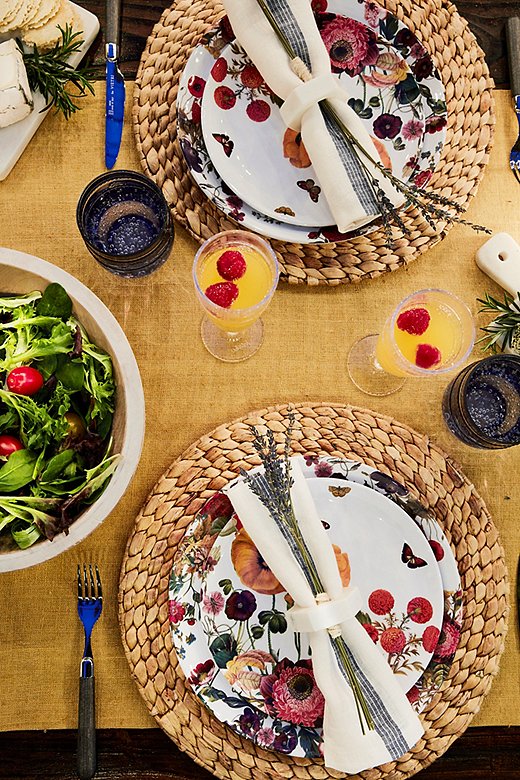 Don’t worry about the wind upsetting your table setting. Use a short runner instead of a tablecloth, or omit a table covering at all. (Another alternative: clipping weights to a tablecloth.) Napkin rings will help napkins stay in place as well. Tucking a few sprigs of lavender in with the napkin makes the meal feel like a special occasion.
